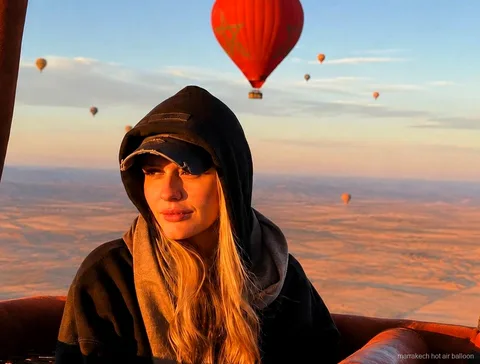 Hot air balloon rising at sunrise over the Marrakech countryside
